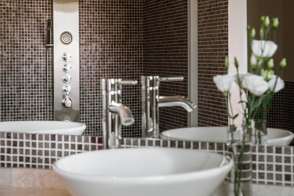 a bathroom with two sinks and a tub and flowers at Villa Mansa in Vistalba