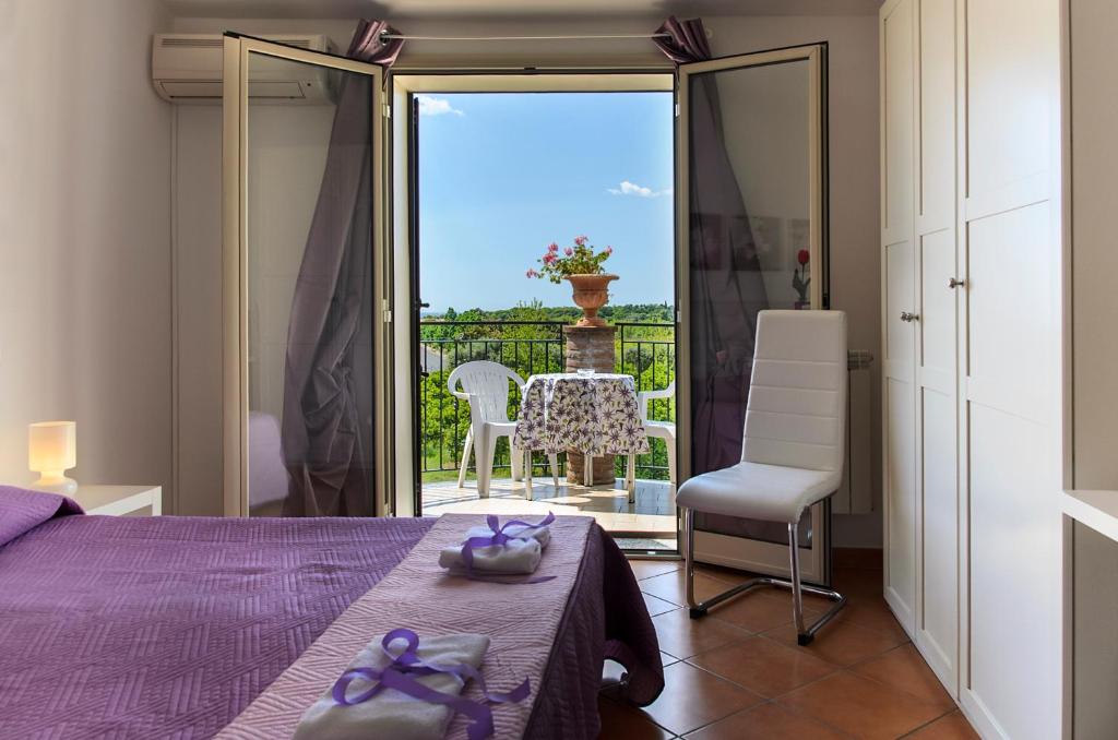 a bedroom with a bed and a table and chairs at B&B La Stella di Naxos in Giardini Naxos