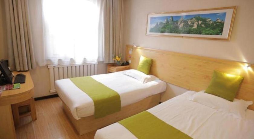 a hotel room with two beds and a desk at Shell Baoding Dongfeng Middle Road Kailian Hotel in Baoding