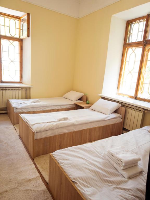 Postel nebo postele na pokoji v ubytování Green Palace