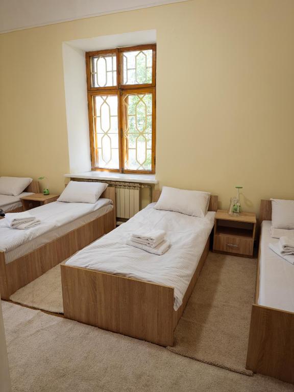 Postel nebo postele na pokoji v ubytování Green Palace