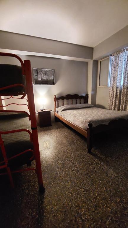 Ένα ή περισσότερα κρεβάτια σε δωμάτιο στο Hostal La Pachamama