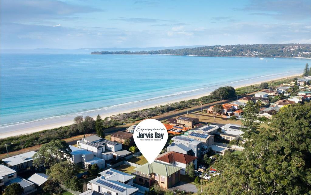 an aerial view of a town with a beach at Ammos by Experience Jervis Bay in Vincentia