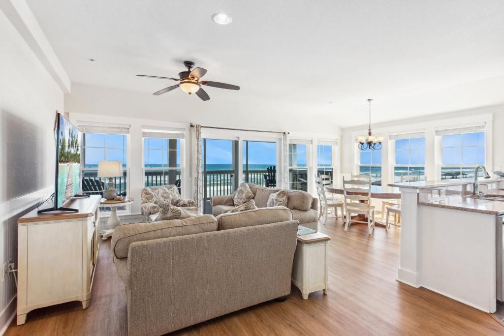a living room with a couch and a ceiling fan at TSC404 - Seaclusion in Kill Devil Hills