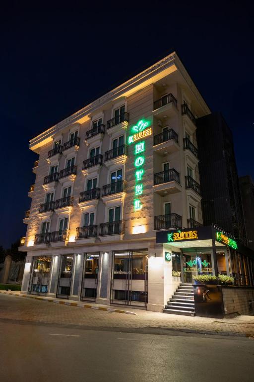 a hotel building with a sign on the front of it at Şişli Luxury K Suites Hotel in Istanbul