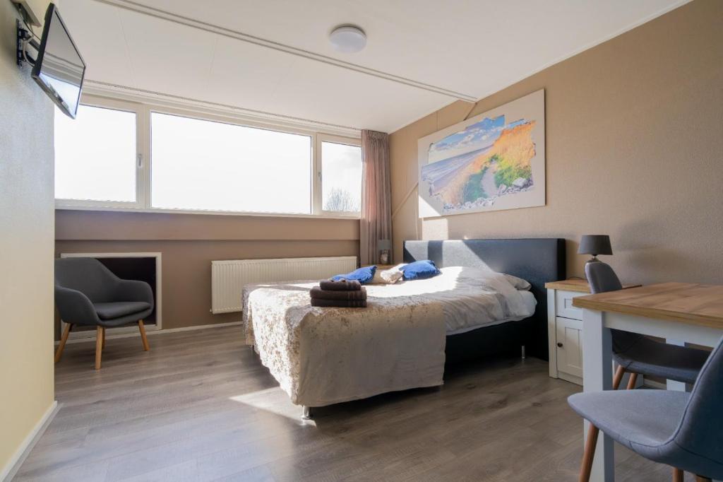 Postel nebo postele na pokoji v ubytování B&B Plompetorenzicht