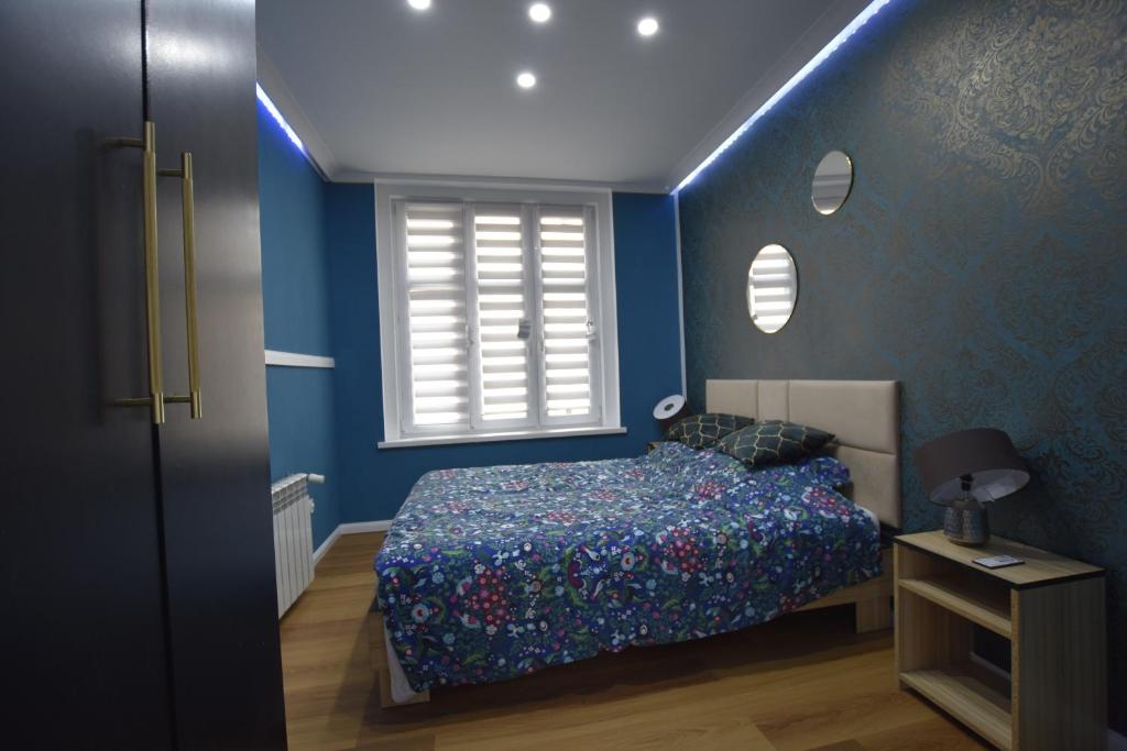Кровать или кровати в номере VacationClub - Piłsudskiego 2 Apartament 2A