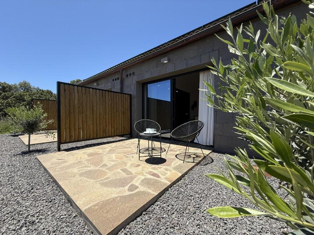 a house with two chairs on a patio at V.V. Verde Amanecer 3 in Las Casas