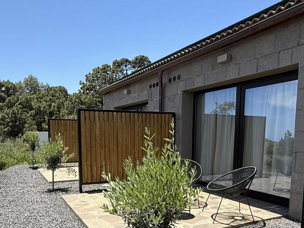 a patio with two chairs and a building at V.V. Verde Amanecer 5 in Las Casas