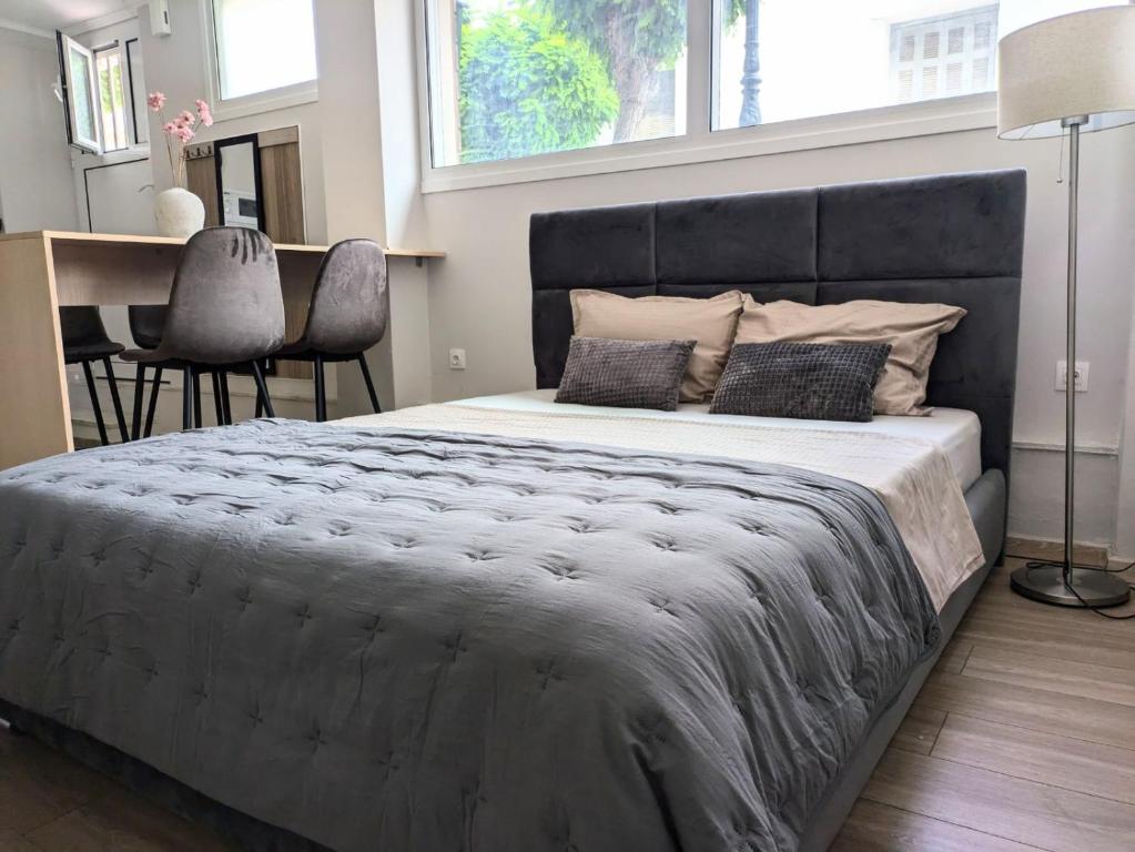 a bedroom with a large bed and a desk at Loutraki central studio in Loutraki