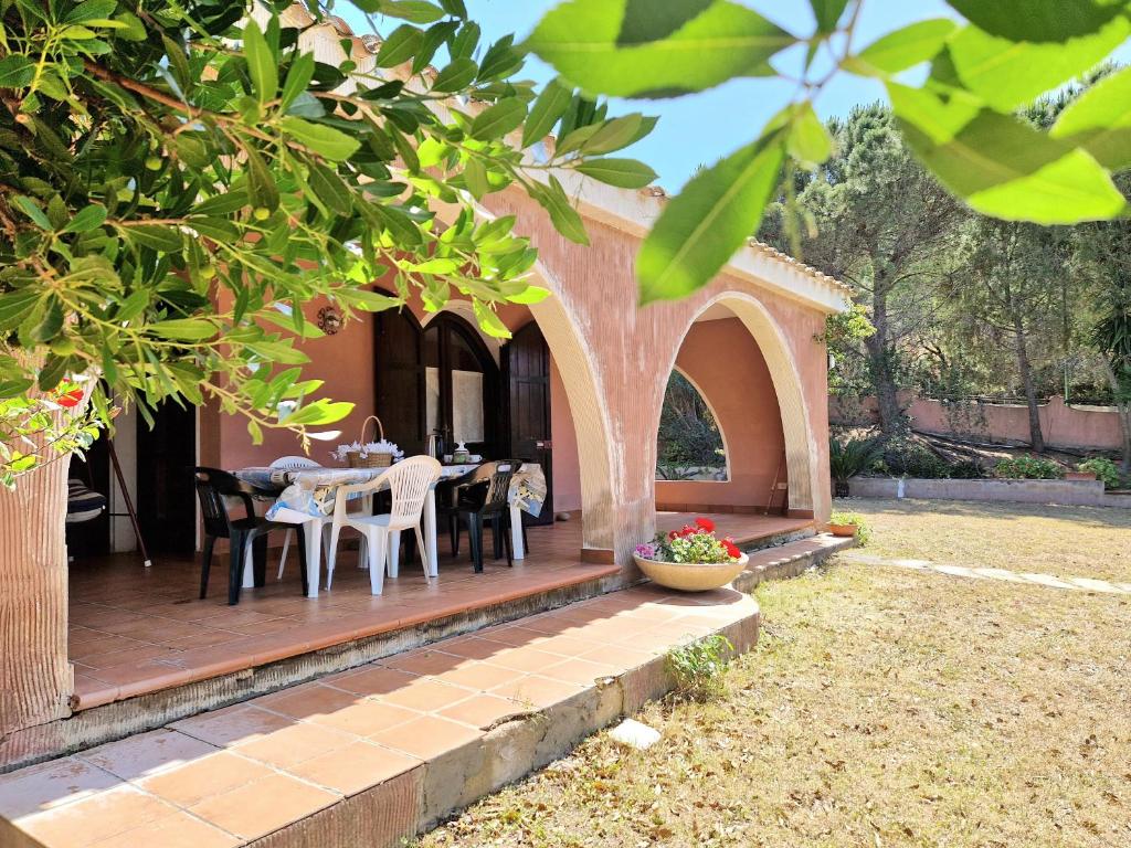 a wooden deck with a table and chairs on it at Villa Rosa Bestvacationever in Torre delle Stelle