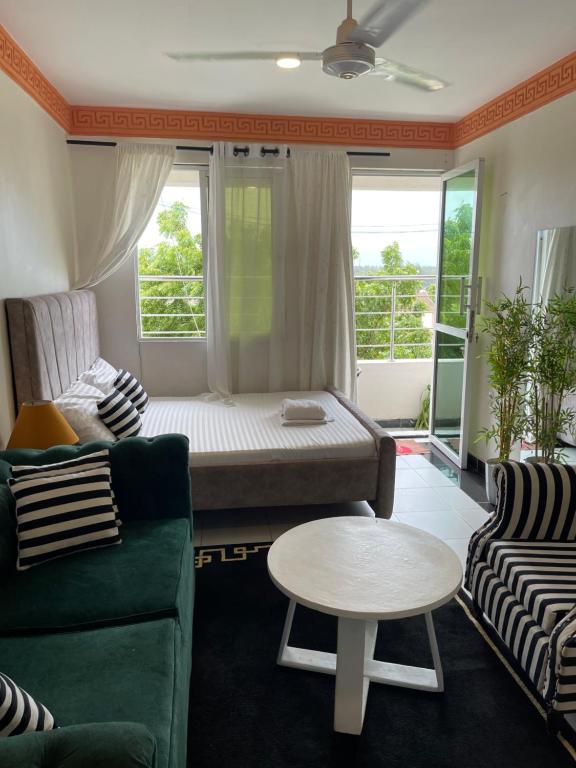 a living room with a couch and a table at bamburi studio in Mombasa