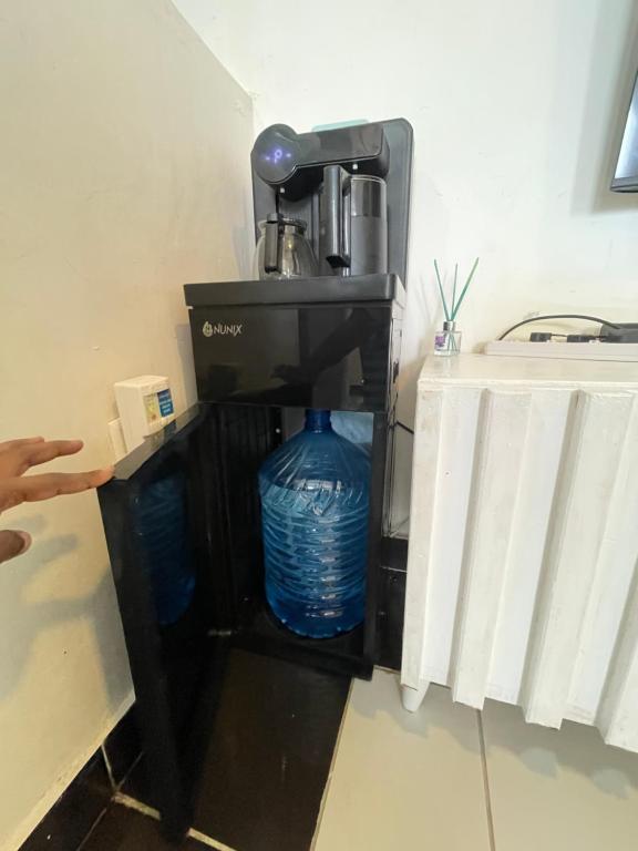 a coffee maker with a blue water bottle in it at bamburi studio in Mombasa