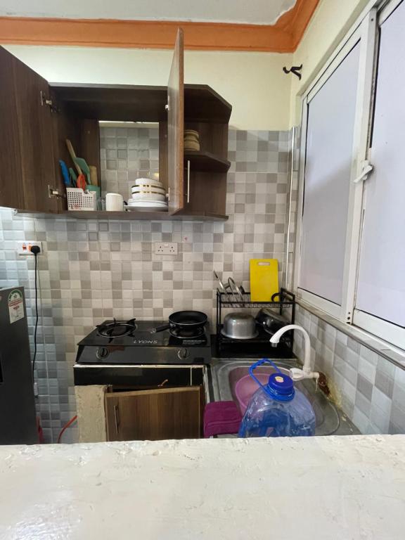 a kitchen with a stove and a sink at bamburi studio in Mombasa