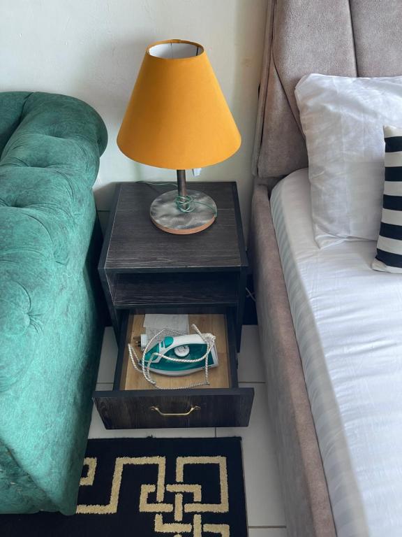 a table with a lamp on it next to a couch at bamburi studio in Mombasa