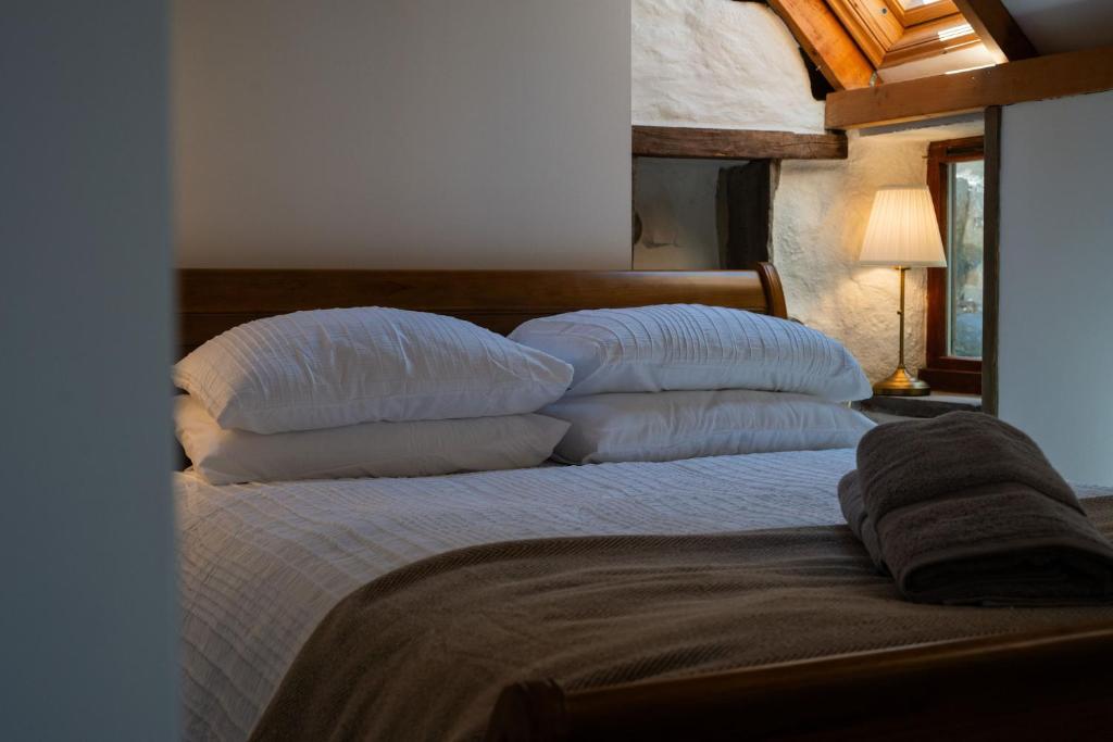 a bedroom with a bed with pillows on it at Nautical Nook, 16 Seatown, Gardenstown in Gardenstown