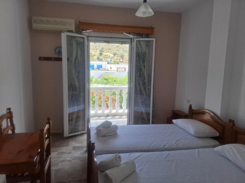 Postel nebo postele na pokoji v ubytování Hotel Galini