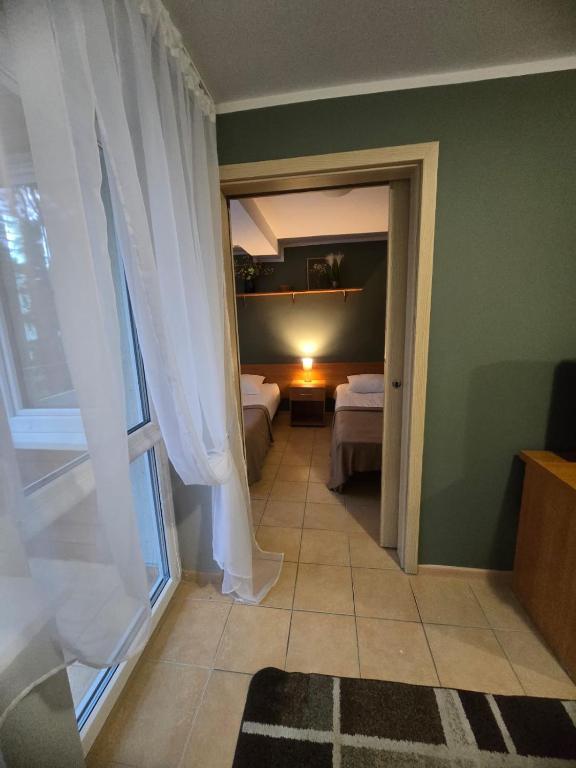 a room with a room with two beds and a window at Ośrodek Wczasowy Bursztyn in Gdańsk