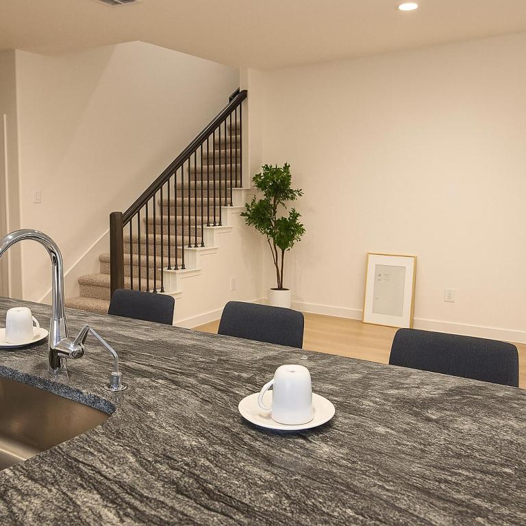 a kitchen with a sink and a counter with plates on it at Quiet Haven in Richmond