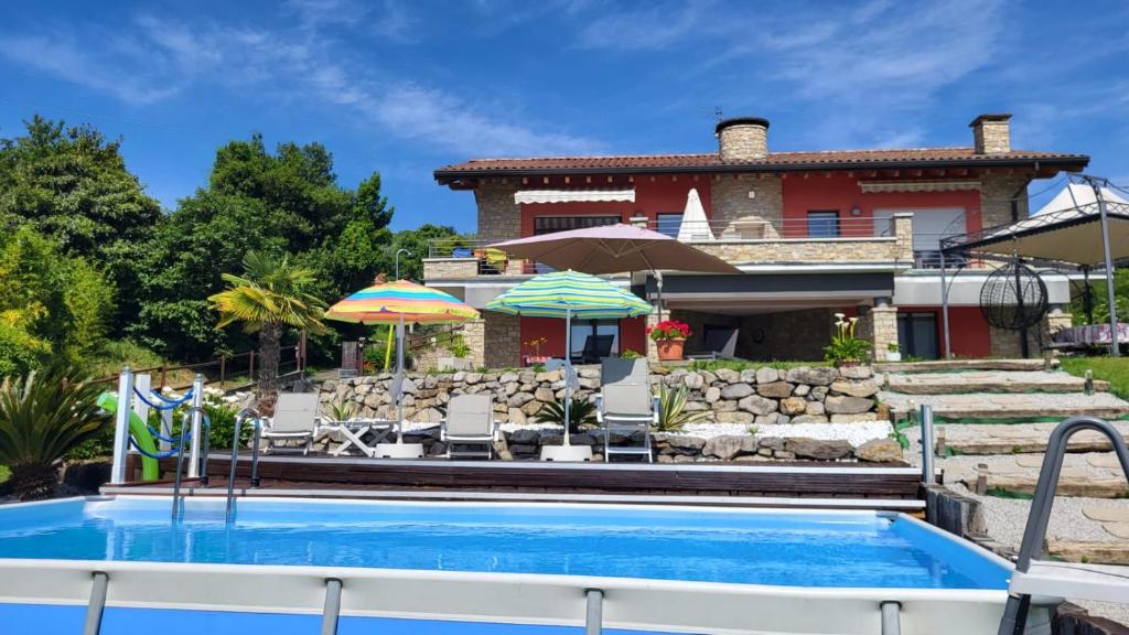 a house with a swimming pool in front of a house at CASA VACANZE RELAX in Riva di Solto
