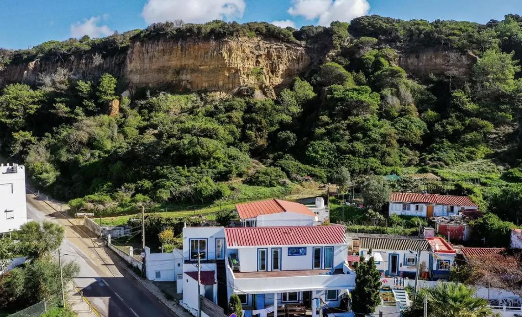 a city with a mountain in the background at Beachfront Caparica in Costa da Caparica