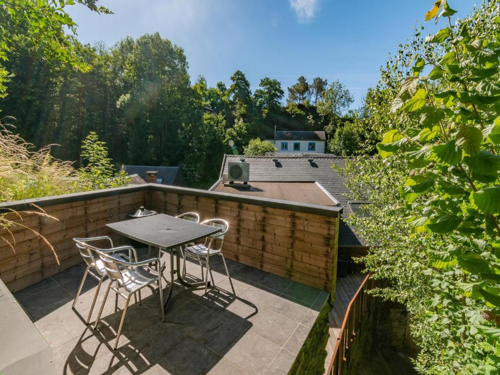 a patio with a table and chairs on a balcony at Holiday Home in La Roche near Center in La Roche-en-Ardenne