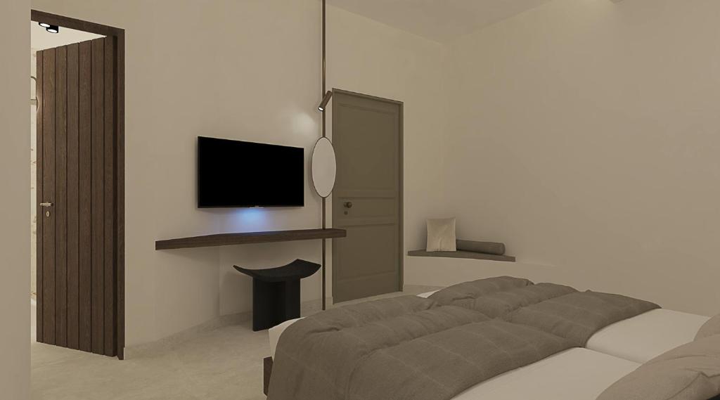 Postel nebo postele na pokoji v ubytování Athiri Santorini Hotel