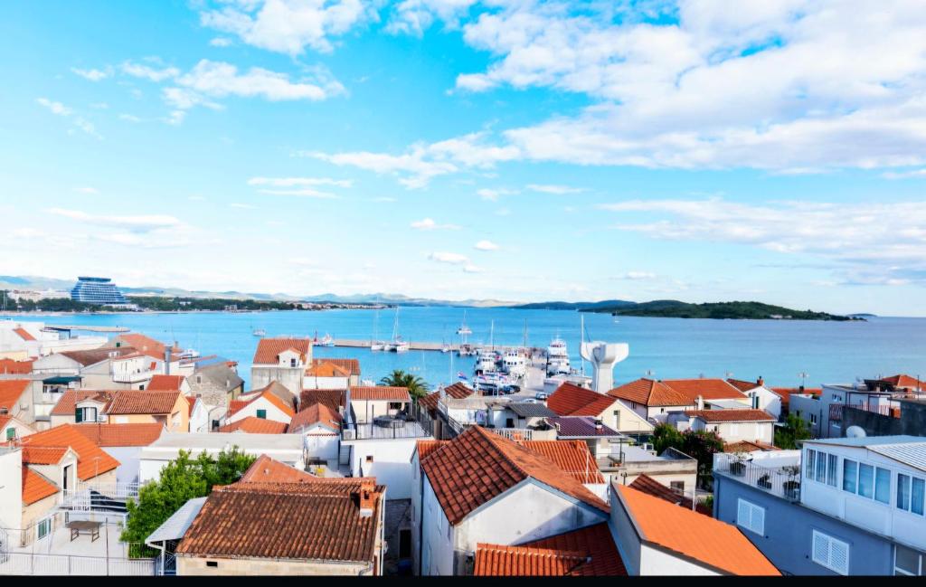 a view of a city with boats in the water at Sobe Mateša in Vodice