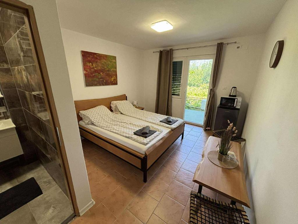 Postel nebo postele na pokoji v ubytování Soti Apartments