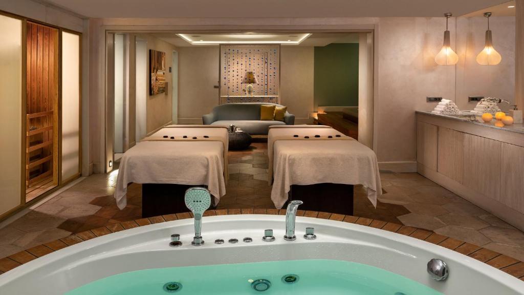 a hotel room with a bath tub and a living room at Crowne Plaza Florya Istanbul by IHG in Istanbul