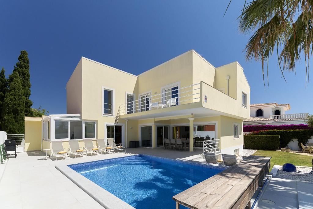 a villa with a swimming pool and a house at Porto de Mos 95 by Destination Algarve in Porto de Mós