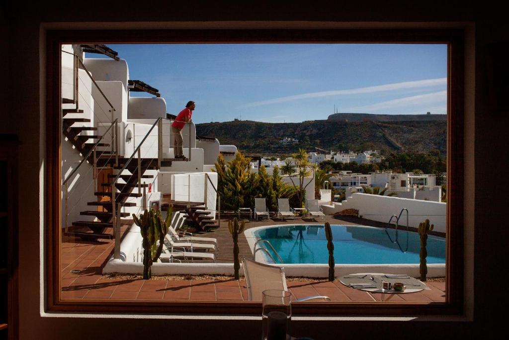 a view of a swimming pool from a hotel window at Boutique Hotel El Tio Kiko in Agua Amarga