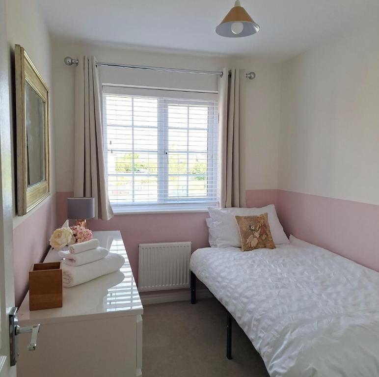 a small bedroom with a bed and a window at 3 bed house Stratford-upon-Avon, River, Theatre and Restaurants in Stratford-upon-Avon