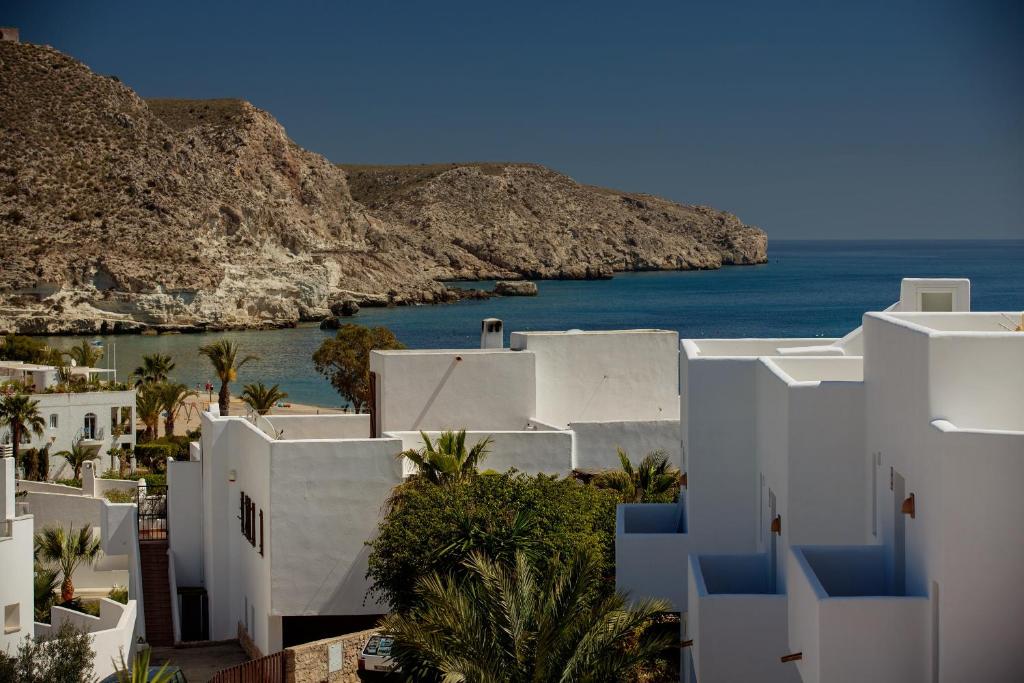 a view of white buildings and the ocean at Boutique Hotel El Tio Kiko in Agua Amarga