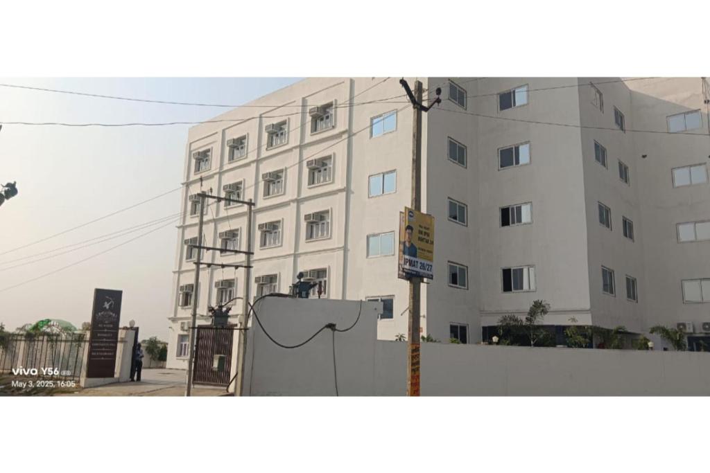 a large white building with a sign in front of it at Hotel Ram Janaki Palace in Tikri Kalān