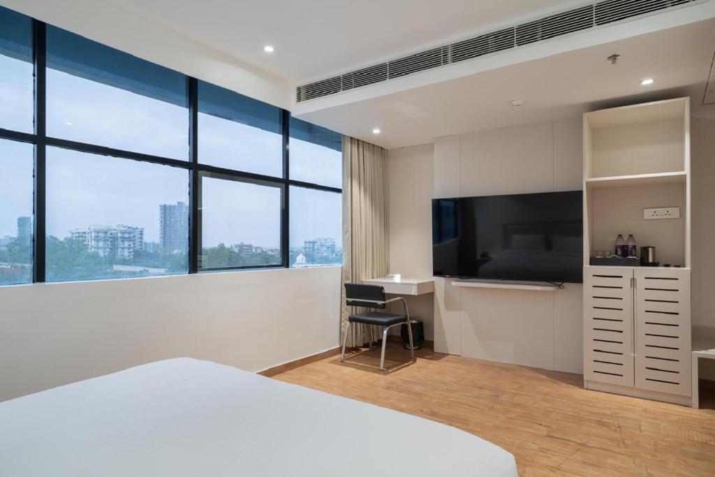 TV a/nebo společenská místnost v ubytování Uptown Hotel
