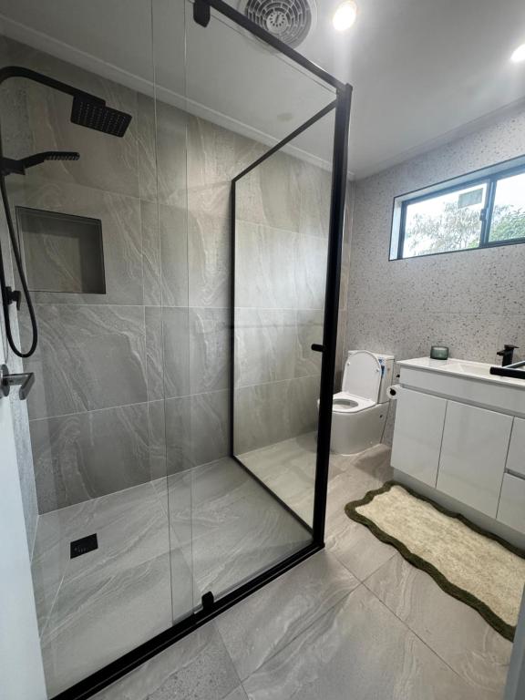 a bathroom with a glass shower with a toilet at Teresa Ct in Rye