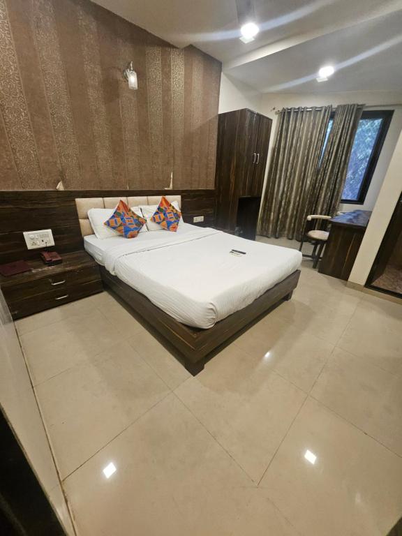 a bedroom with a bed with two pillows on it at Prime Hotel Addore Palácée - Near Mumbai Airport , Visa Consultant , Jio World Convention Centre BKC in Mumbai
