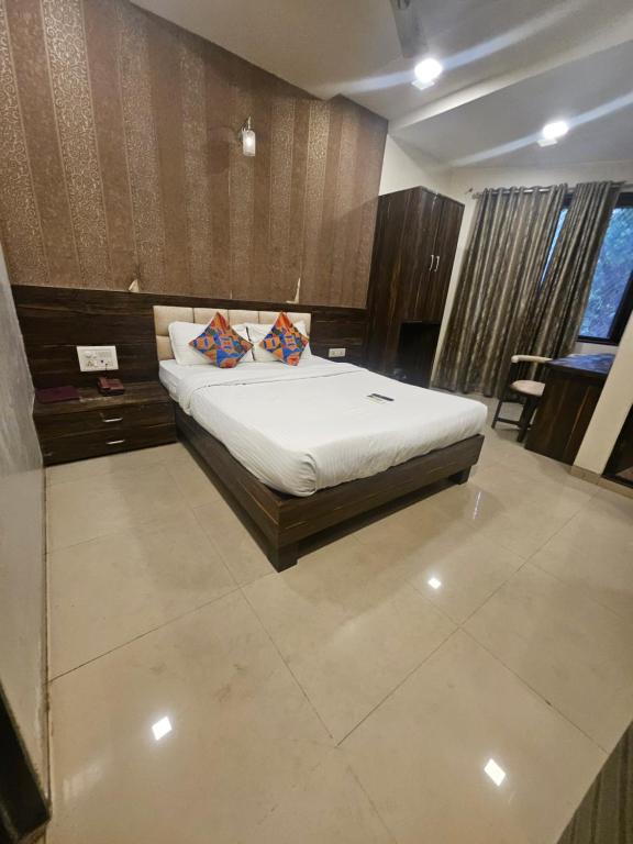 a bedroom with a bed with white sheets and pillows at Prime Hotel Addore Palácée - Near Mumbai Airport , Visa Consultant , Jio World Convention Centre BKC in Mumbai