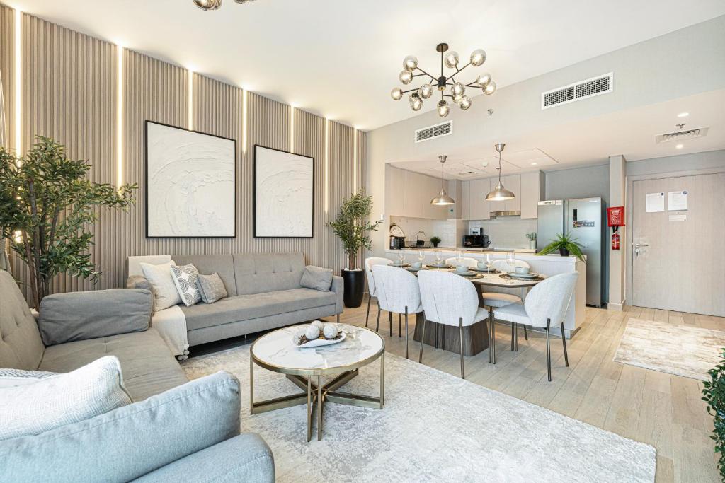 a living room with a couch and a table at Luxury 4 Bedroom Apartment with Ferrari World and Sea Views, Yas Island Waterfront, Pool, Gym, Playground, Walk to Yas Mall in Abu Dhabi