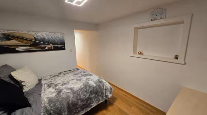 a bedroom with a bed and a painting on the wall at Ferienwohnung Klein in Schönau am Königssee