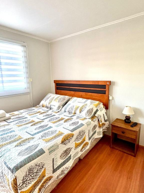 a bedroom with a bed with a comforter on it at Hostal Mi Casa in Canela Baja