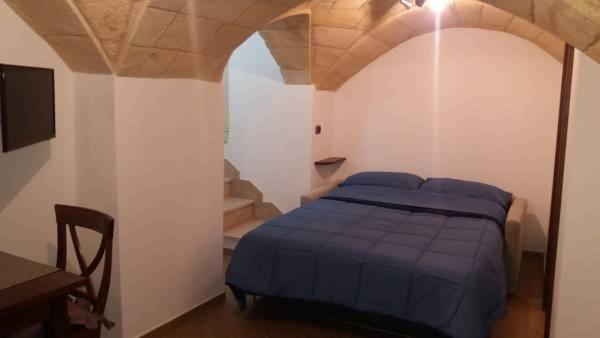 Postel nebo postele na pokoji v ubytování L'Angolo del Salento