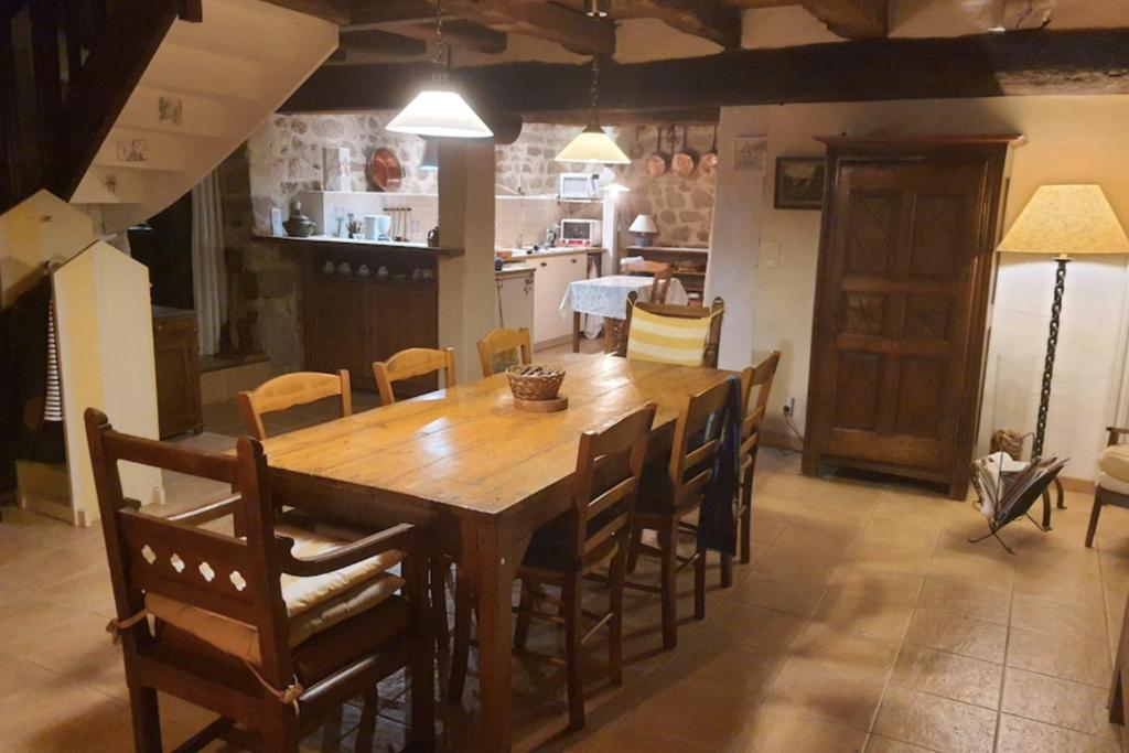 une salle à manger avec une table et des chaises en bois dans l'établissement Charming spacious 150 m old house in Berric, à Berric