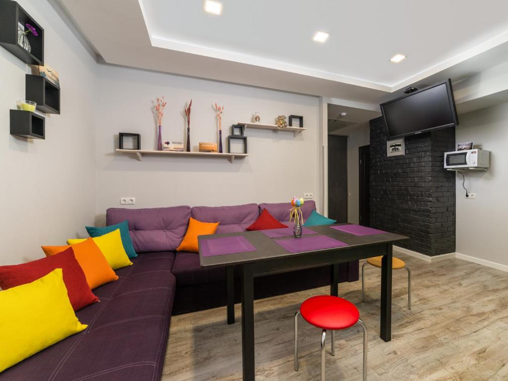 a living room with a purple couch and a table at Light Life Hostel in Kyiv