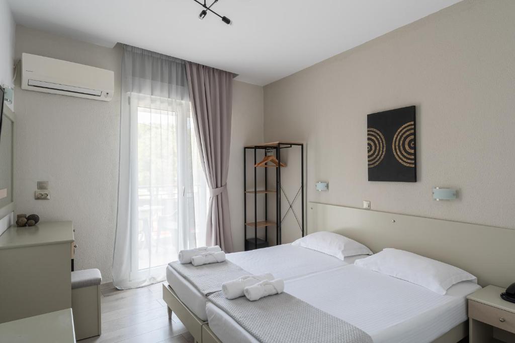 Postel nebo postele na pokoji v ubytování Hotel Akropol