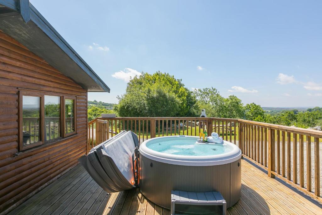 a hot tub on the deck of a house at Costentyn, Tor Down Quarry in Bodmin