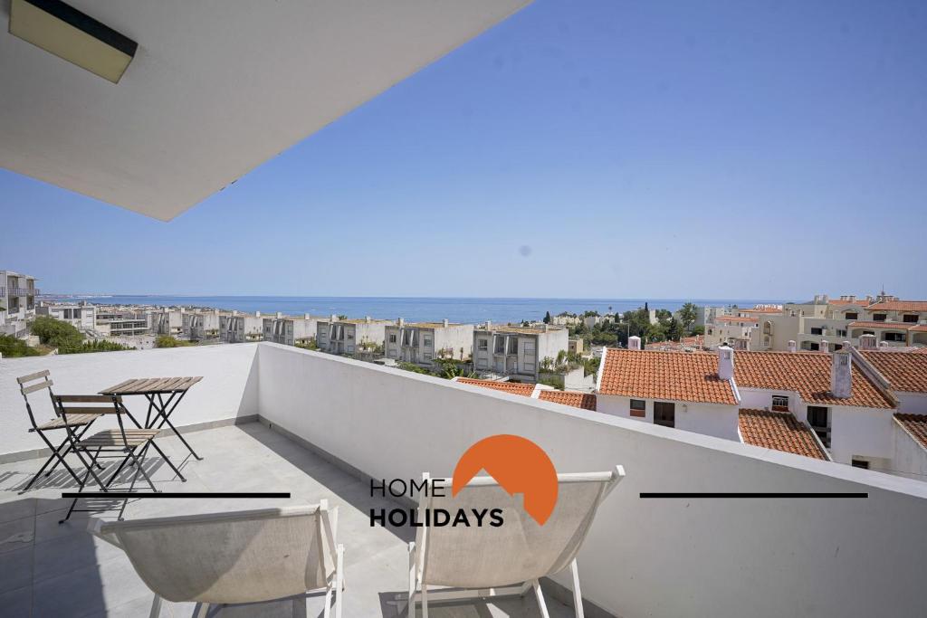 a balcony with chairs and a view of the city at #171 Páteo 2 Flat by Home Holidays in Albufeira