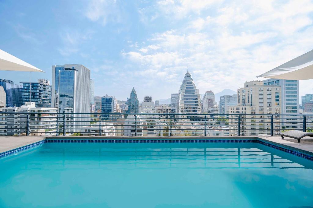a swimming pool with a view of the city at Time Suite - Comfort Apartments in Santiago