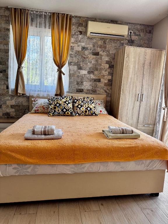 a bedroom with a large bed with two towels on it at Apartments Tadic in Petrovac na Moru